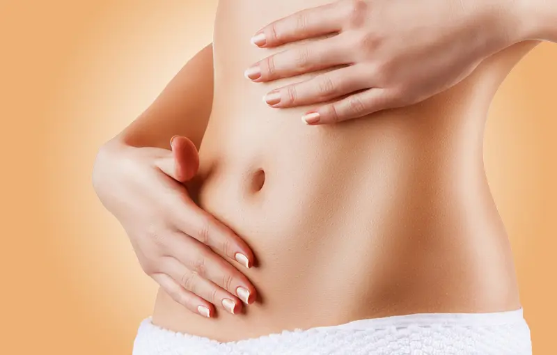 Perfect slim toned young body of brunette sensual girl, fit woman at studio. The fitness, diet, sports, plastic surgery and aesthetic cosmetology concept. Long legs.