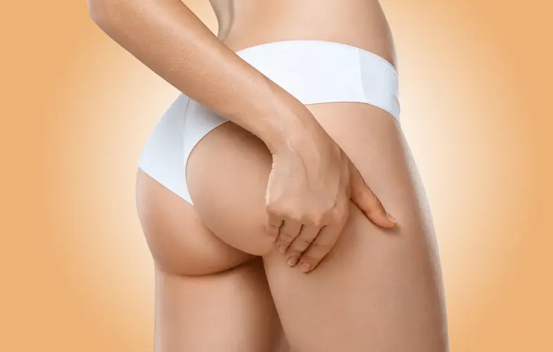 Perfect slim toned young body of brunette sensual girl, fit woman at studio. The fitness, diet, sports, plastic surgery and aesthetic cosmetology concept. Long legs.